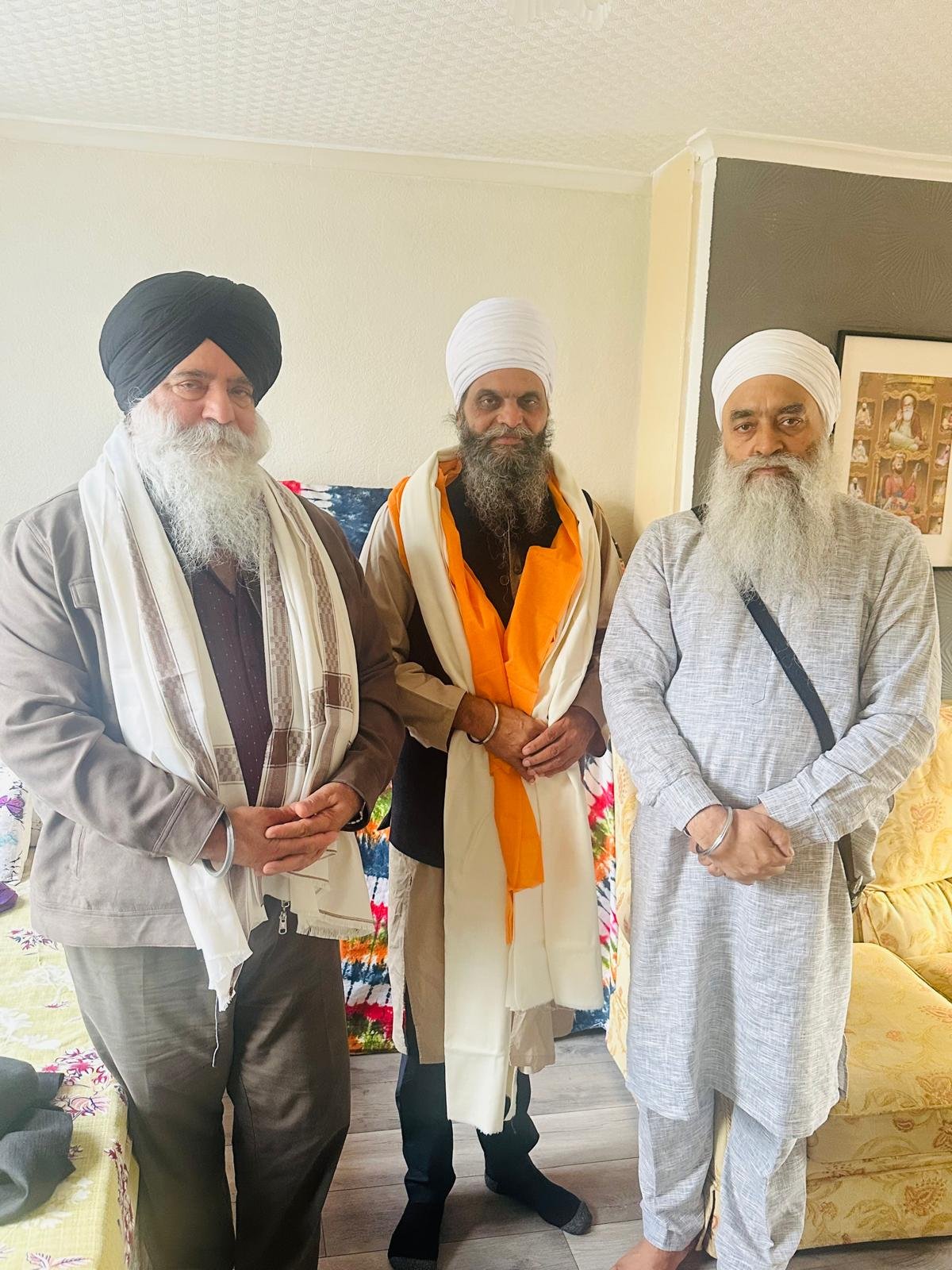 Pres. Balbinder S. Nanuwan with sangat during a home visit